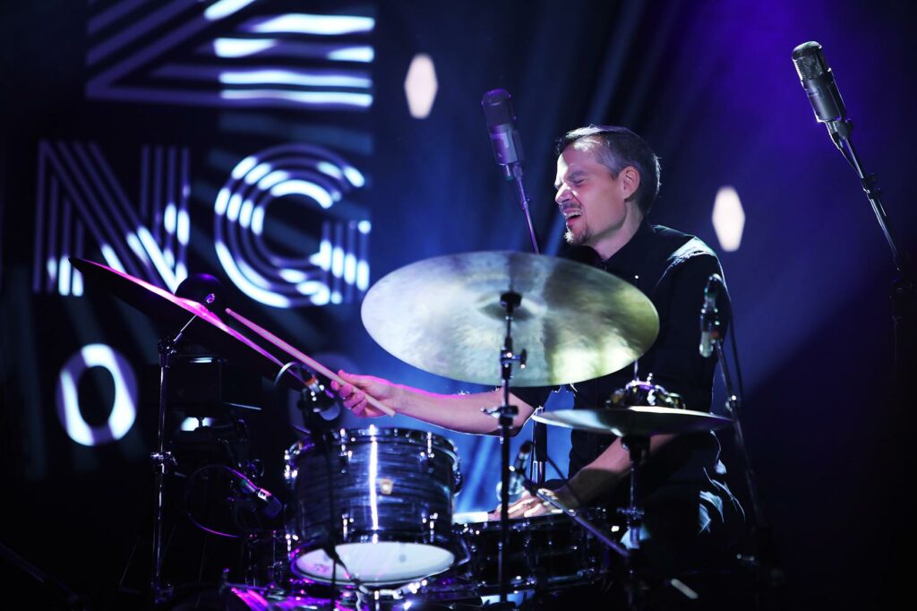 Teppo Mäkynen plays the drums at Tampere Jazz Happening, smiling.
