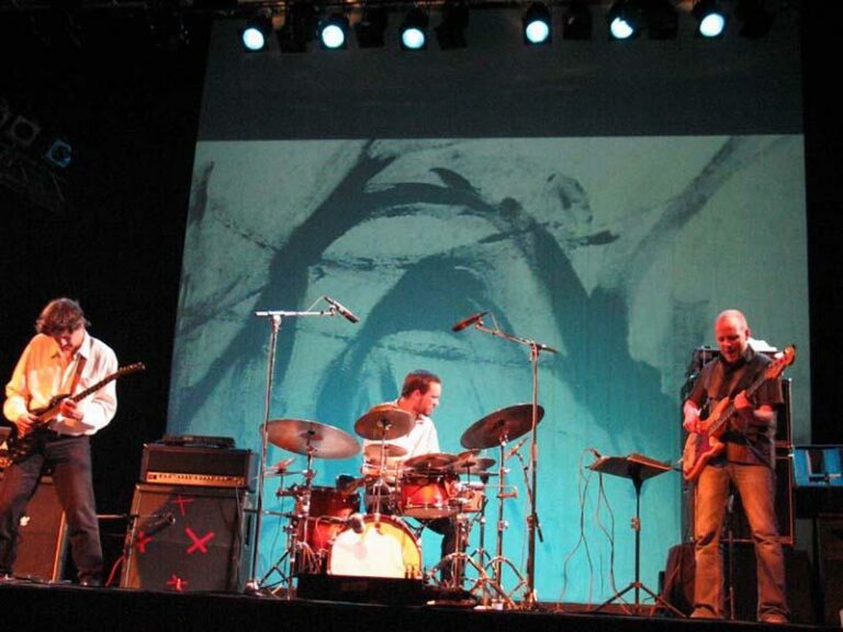 Scorch Trio is performing on the stage.