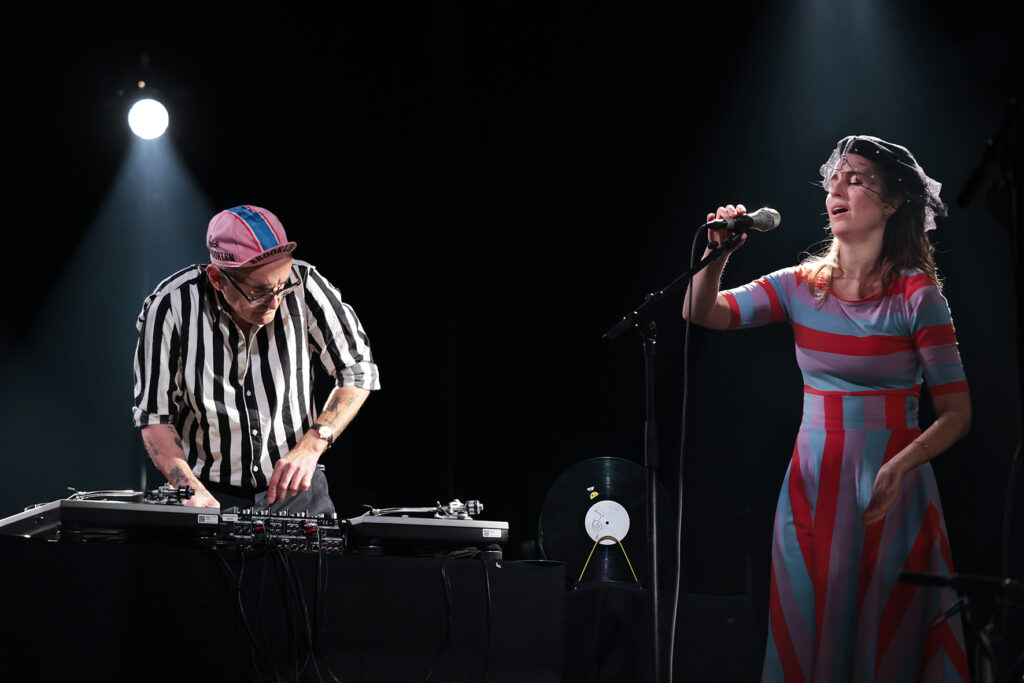 How Noisy Are The Rooms? is performing on the stage.