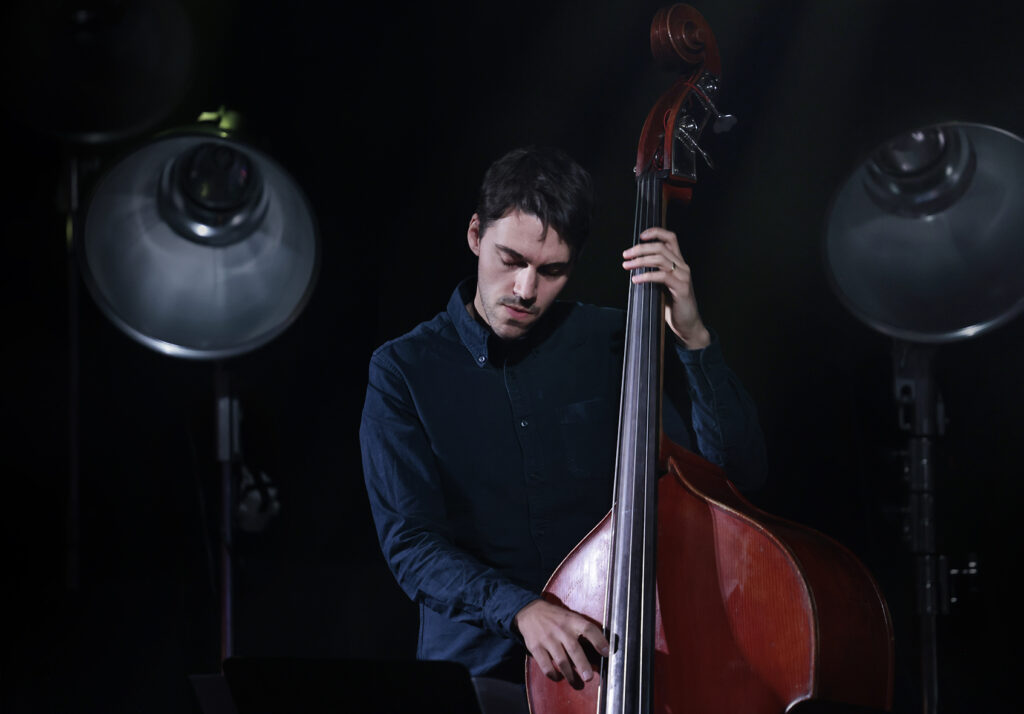 Tom McCredie is playing the bass.