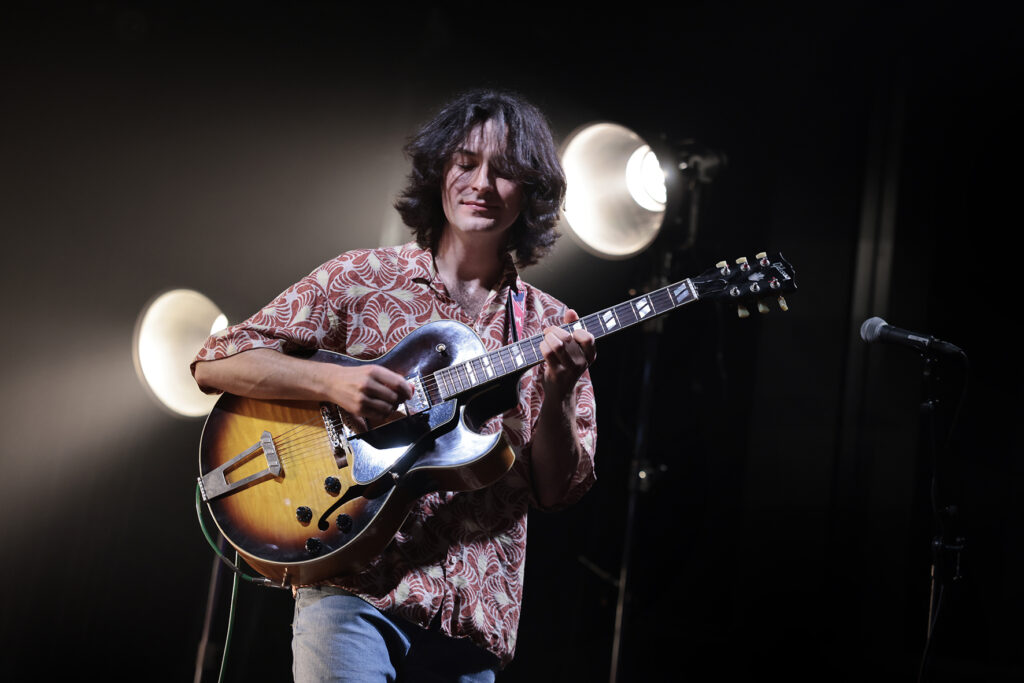 Rob Luft is playing the guitar.