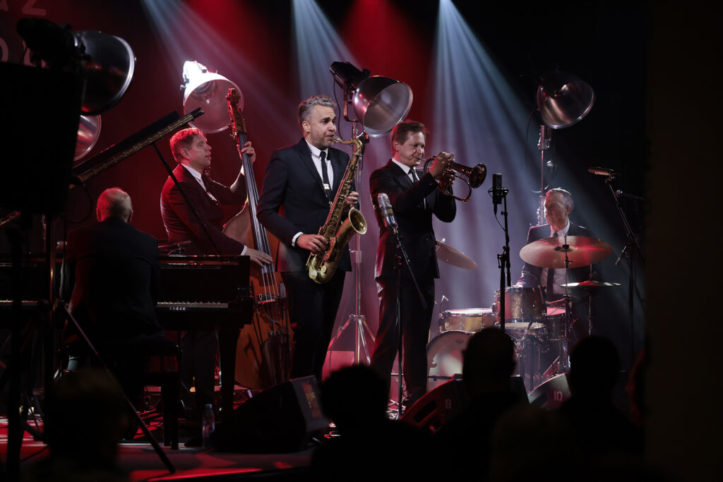 The Five Corners Quintet is performing on the stage.