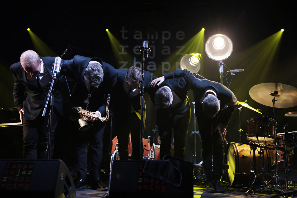 The Five Corners Quintet is bowing to the audience.