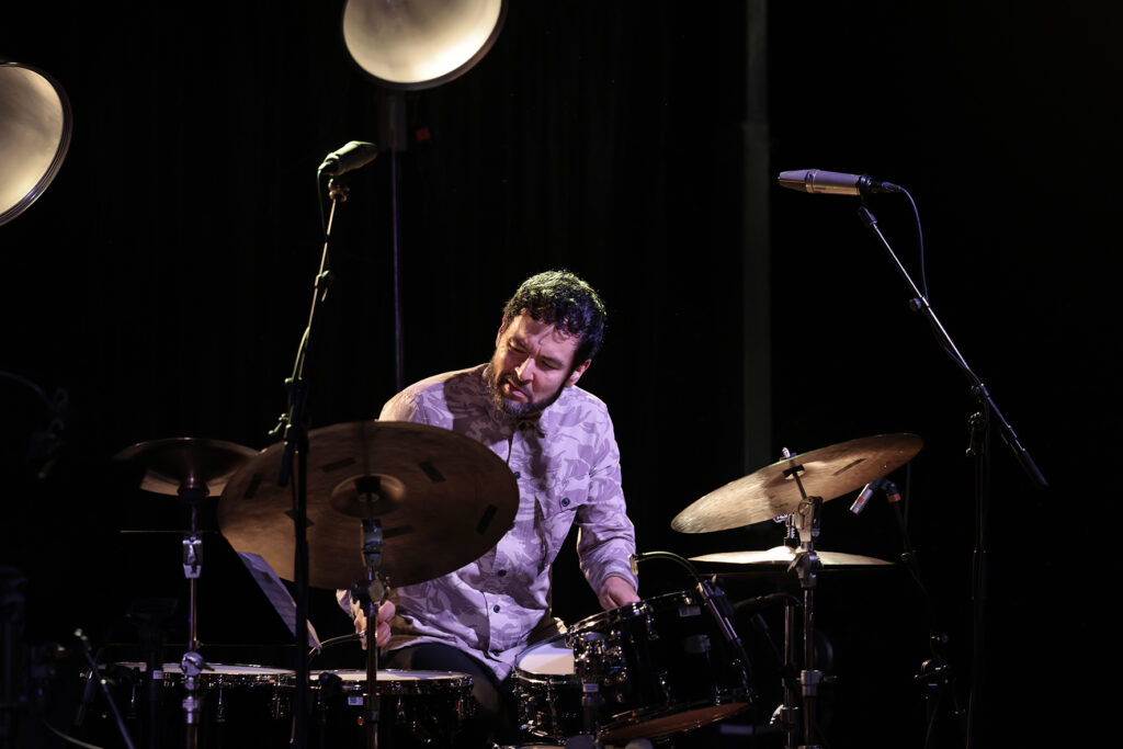 Tomas Fujiwara is playing the drums.
