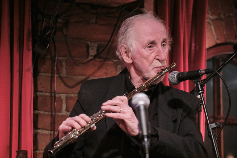 Juhani Aaltonen is playing the flute.