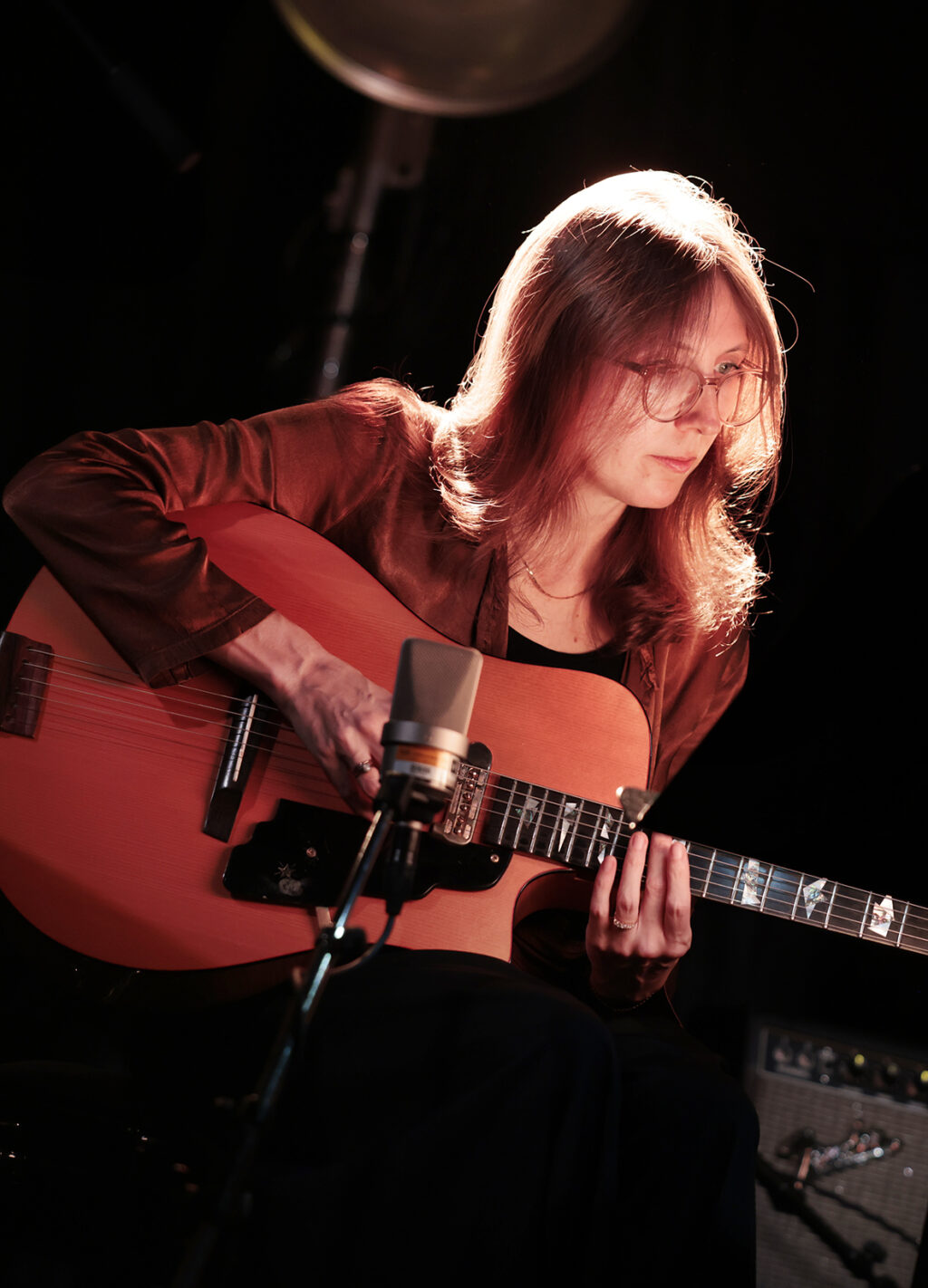 Mary Halvorson is playing the guitar.