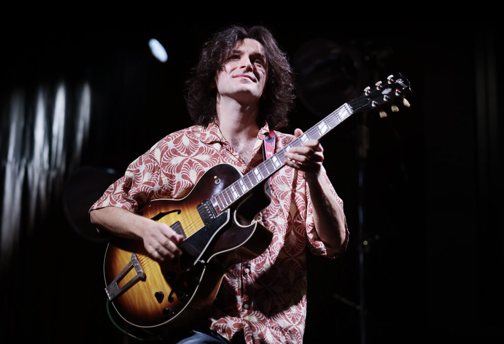 Rob Luft is playing the guitar.