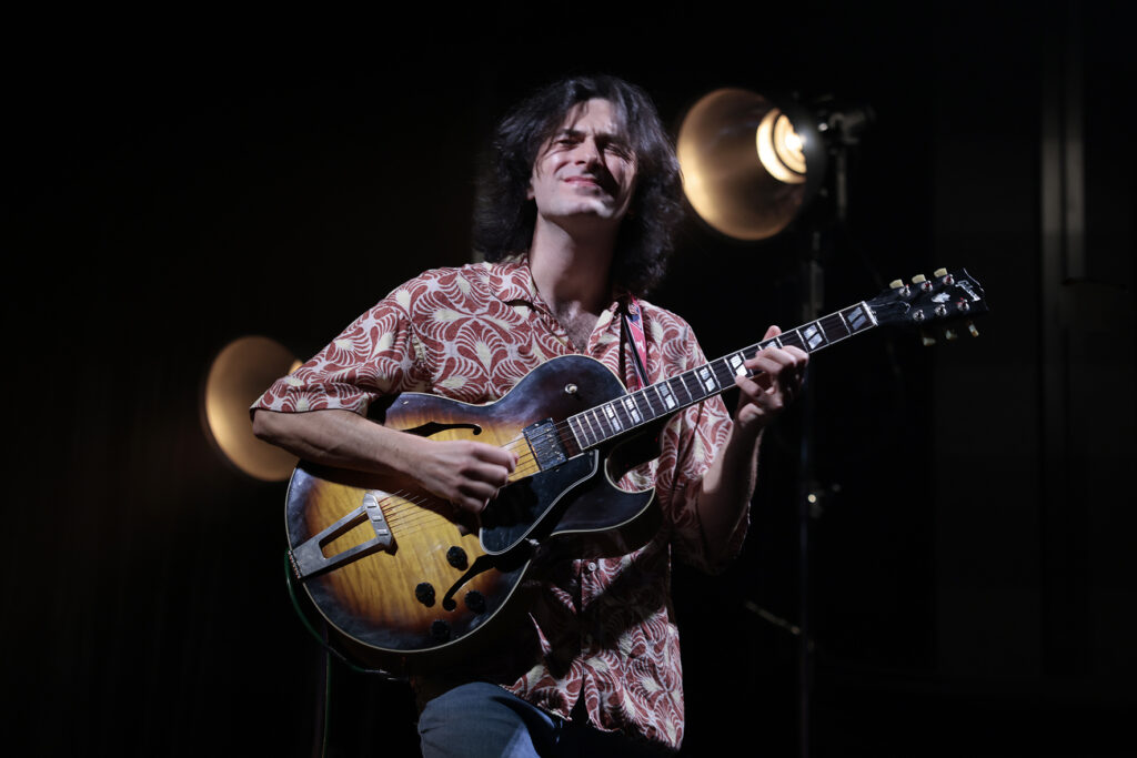 Rob Luft is playing the guitar.