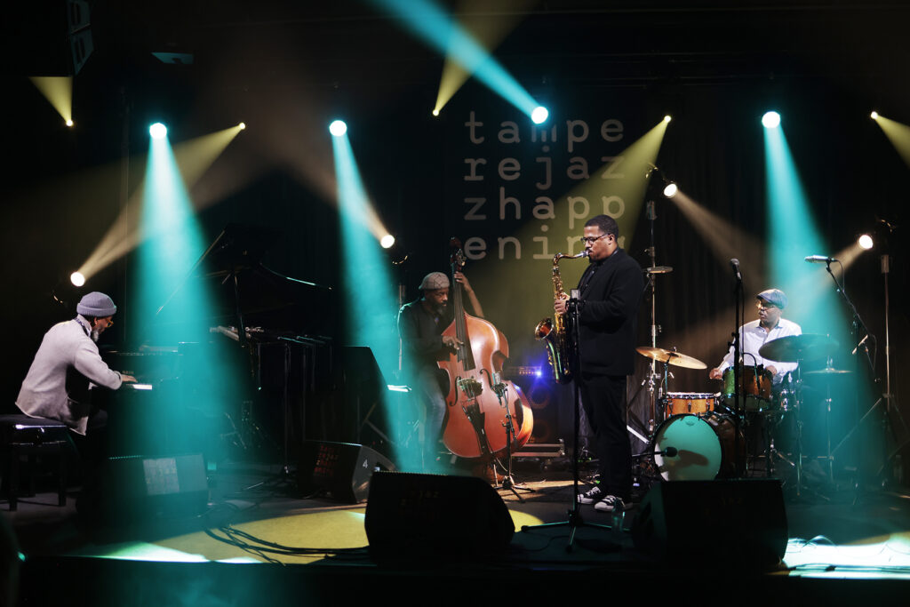 James Brandon Lewis Quartet is performing on the stage.